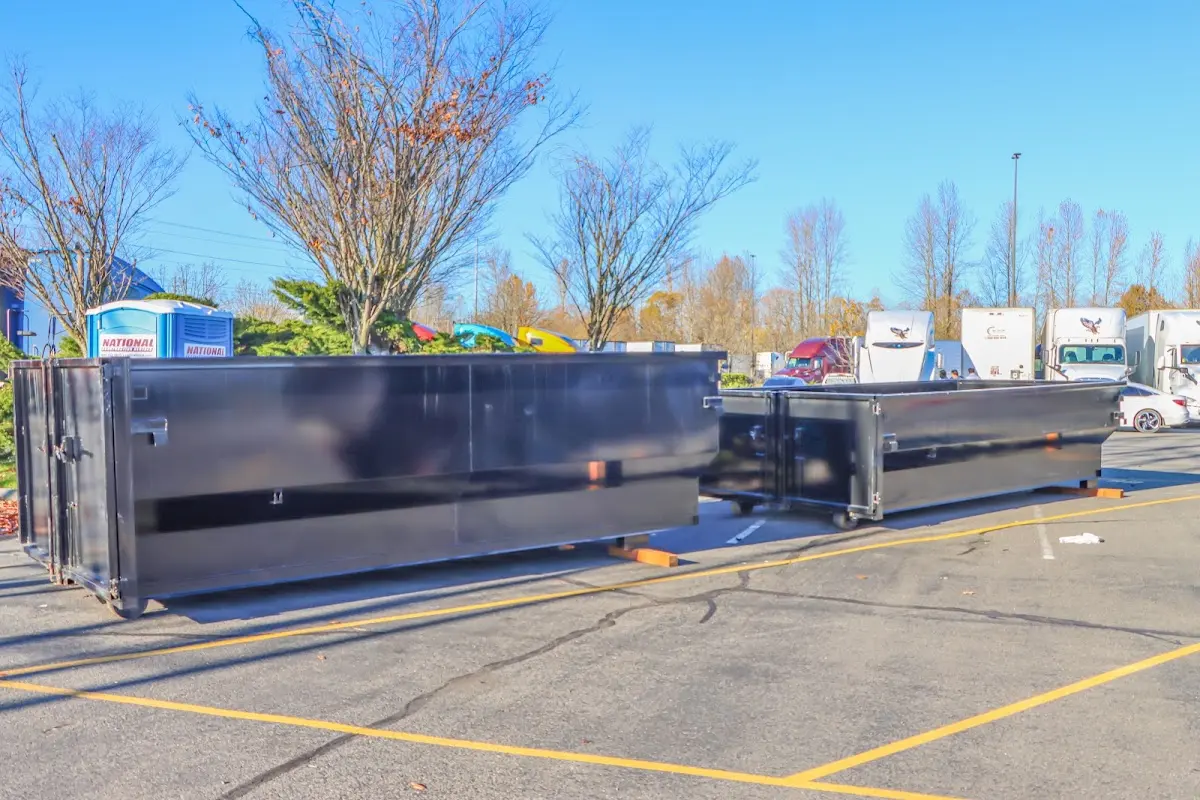 Professional dumpster rental service with roll-off container on residential driveway in Upper Deerfield